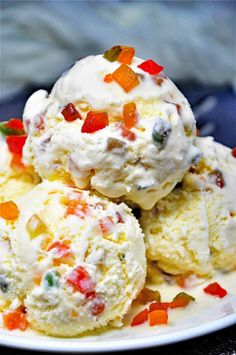 three scoops of ice cream on a white plate with gummy bears in it