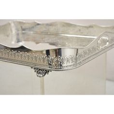 an ornate silver tray on a white table