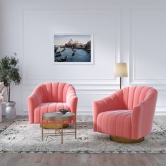 a living room with two pink chairs and a coffee table in front of a painting on the wall