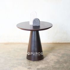 a round table with a metal object on it's top that says puros furniture