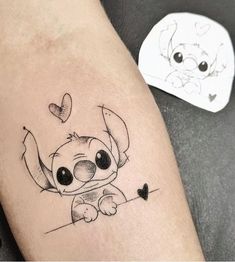 a tattoo on the leg of a person with a small dog and heart in it