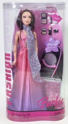 a barbie doll in a pink and purple dress with makeup on it's face