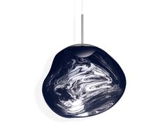 a black and white marbled object hanging from a metal hook on a white wall