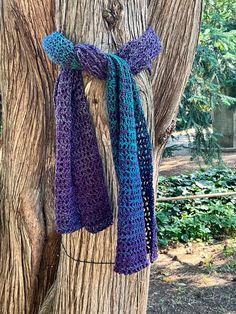 a purple and blue scarf hanging from a tree