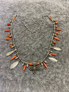 This is a beautiful old silver necklace from southern morocco with small silver boghdad pendant,small charmant pendants, natural Coral. It is a very original jewel with sober and refined design. It is a well shaped example, with a stepped front and little bobbles, typical of this type of jewel, which is increasingly becoming more rare. Length of the necklace : 46,5cm Length of the Boghdad pendant : 2,3cm Weight : 63,7g Moroccan Necklace, Moroccan Jewelry, Natural Coral, Classic Jewelry, Silver Accessories, Ethnic Jewelry, Silver Cross, Necklace Gift, Necklace Silver