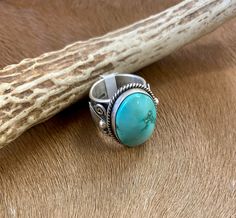 Be bold and unique with this absolutely stunning sterling silver statement Turquoise Oval Ring. Featuring a large beautiful turquoise oval stone set in a thick band, this size 6.5 ring will be sure to make a statement. Show off your style and sparkle with this one-of-a-kind accessory! This beautiful sterling silver unique turquoise ring was made by the talented Native American artist silversmith Donovan Cadman. The ring is stamped and signed by the artist inside of the ring band. This ring is su Unique Silver Turquoise Ring With Oval Cabochon, Collectible Multi-stone Turquoise Oval Ring, Silver Turquoise Ring, Oval Shape, Gift, Silver Oval Cabochon Turquoise Ring Gift, Oval Turquoise Multi-stone Ring In Sterling Silver, Deodorant Stains, Makeup Stain, Native American Artists, Onyx Jewelry