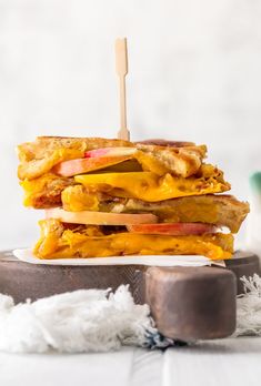 a grilled cheese and apple sandwich on a plate with a toothpick in it