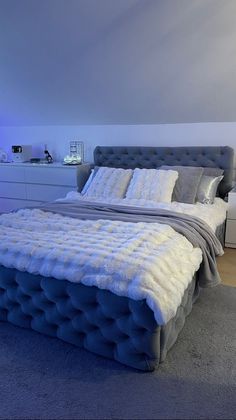 a large bed sitting in the middle of a bedroom