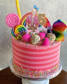 a birthday cake decorated with candy, candies and an image of a woman on top