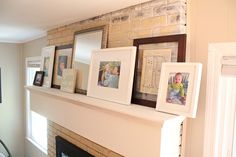 a mantle with pictures and frames on it in a living room next to a fireplace