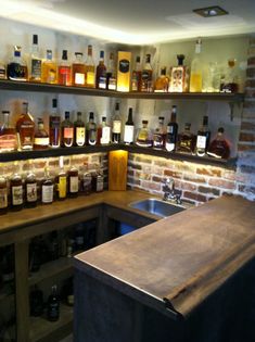 the shelves are filled with bottles of liquor and other things on display in the kitchen