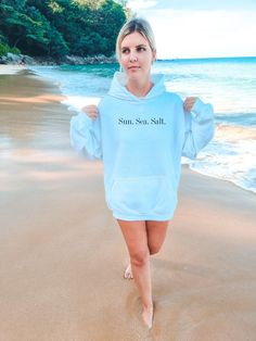 "sun. sea. salt summer hoodie | word sweatshirt | 2023 beach sweatshirt | | positive | hoodie gift daughter | surf | California sweatshirt | VSCO Get ready to make a statement with this 2023 summer hoodie from Gildan, featuring the words \"Sun. Sea. Salt.\" on the front. This stylish and comfortable hoodie captures the positive vibes of a California summer, making it the perfect addition to your wardrobe. Whether you're hitting the beach for some surf and sand or just soaking up the sun, this hoodie is sure to keep you looking and feeling your best. Made with high-quality materials, it's designed to withstand all your summer adventures, from early morning runs to late night bonfires. If you're looking for a thoughtful gift for your daughter or a loved one, this 2023 summer hoodie is a grea Summer Hoodie Sweatshirt With Letter Print, Summer Letter Print Hoodie Sweatshirt, White Summer Hoodie Sweatshirt, White Hoodie Sweatshirt For Summer, White Cotton Hoodie For Vacation, Cotton Relaxed Fit Hoodie For Beach Season, Relaxed Fit Cotton Hoodie For Beach Season, White Letter Print Hoodie For Beach Season, White Relaxed Fit Hoodie For Beach Season