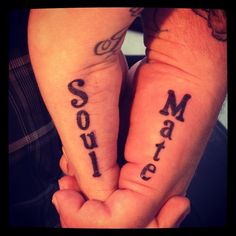 two people holding hands with tattoos on their arms and the words sons and sisters written in black ink