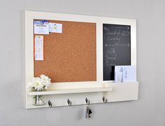 a cork board mounted to the side of a wall