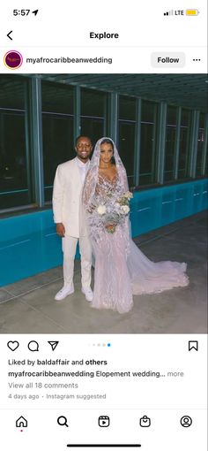 two people standing next to each other in front of a building and one person is wearing a wedding dress