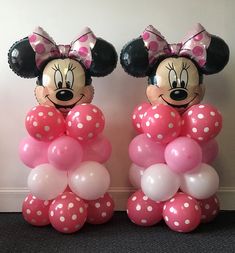 two minnie mouse balloons sitting next to each other