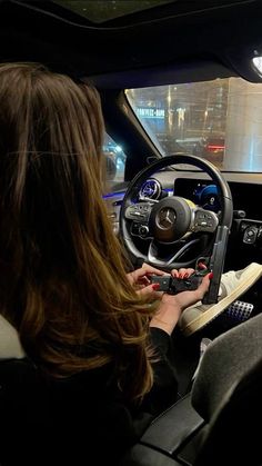 a woman sitting in the driver's seat of a car