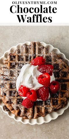 chocolate waffles with whipped cream and raspberries on top