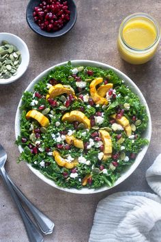 a salad with oranges, nuts and feta cheese on top in a bowl