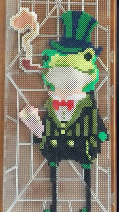 a cross stitch pattern of a lepreite holding a flower