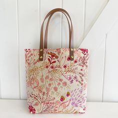 Small, simple tote with just enough room to fit a notebook, piano books or laptop.  Specs: Approx 15"x14" Faux leather straps Small gusset bottom 2 interior slip pockets Add a matching coin purse, boxy bag or coordinating pouch for more interior storage ideas! Or for gifting! Floral Print Canvas Tote Bag For Everyday Use, Rectangular Floral Canvas Bag For Everyday Use, Everyday Floral Print Canvas Tote Bag, Everyday Rectangular Floral Print Canvas Bag, Floral Print Canvas Tote Shoulder Bag, Rectangular Floral Print Canvas Shoulder Bag, Pink Bag With Canvas Lining For Daily Use, Rectangular Canvas Bag With Floral Print, Rectangular Canvas Bags With Floral Print