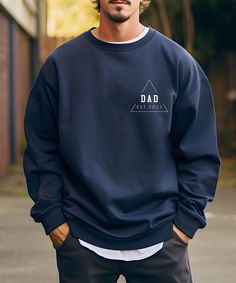 a man wearing a sweatshirt with the word dad on it in front of his face