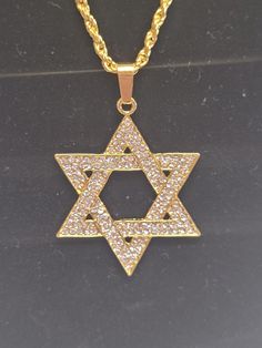 Large cubic zerconia and gold star of David necklace Width: 3 1/2cm Height: 5cm Chain length: 22in Jewish Jewelry Necklaces, David Star, Star Of David Necklace, Jewish Culture, Star Of David Pendant, Jewish Jewelry, Star Chain, Star Of David, Gold Star