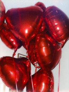 bunch of red heart shaped balloons tied together