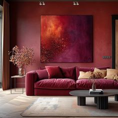 a living room filled with furniture and a large painting on the wall above it's couch