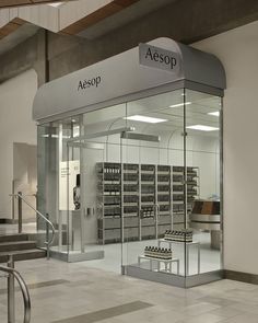 an aesop store with glass doors and stairs