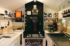 a room with many bottles and other items on the shelves, including an electronic device