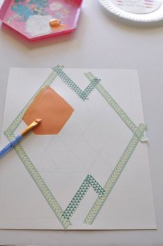 a piece of paper that has been cut into squares with a paintbrush on it