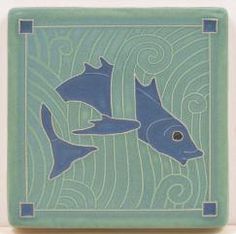 two blue fish swimming in the ocean on a green tile wallpaper with waves and swirls