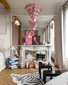 a living room filled with furniture and a fire place in the middle of it's wall