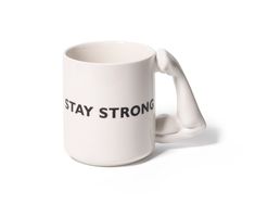 a white coffee mug with the words stay strong on it