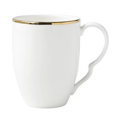 a white coffee cup with gold rim