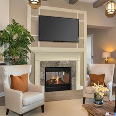 a living room filled with furniture and a flat screen tv mounted above a fire place