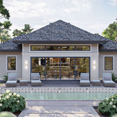 a pool house with lounge chairs around it