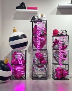 three metal baskets filled with pink and white items on top of a hard wood floor