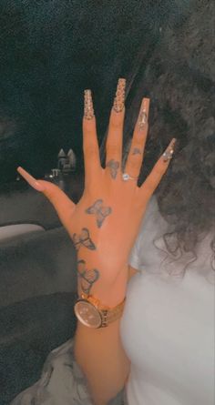 a woman's hand with tattoos on it