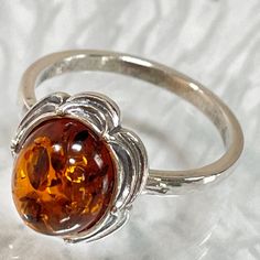 Classic Round Gemstone Flower Ring, Classic Oval Flower Ring, Classic Flower Gemstone Jewelry, Classic Flower-shaped Gemstone Jewelry, Classic Amber Sterling Silver Ring, Classic Hallmarked Flower-shaped Jewelry, Classic Sterling Silver Flower Jewelry, Classic Sterling Silver Flower Ring For Gift, Classic Silver Oval Flower Ring