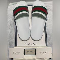 Mens Sz 10uk / 11us Gucci Signature Stripe Slide Sandals In White Mens (Unisex) Authentic Gucci Signature Stripe Slide Sandals * Authentic Includes Box, Dust Bags, Cards, Sku. Never Been Worn. Minimal Oxidation On The Top Of The Straps. Pls See Photos For Closer Look. Serial Number Marked On The Inside Of Straps. Color : White Size 10uk / 11us Product Details Slip On Signature Stripe Rubber Toe Strap Logo At Sole Edge Synthetic Upper And Lining, Rubber Sole Made In Italy Retail: $400 White Flat Gucci Slides, Classic White Slides With Round Toe, Designer White Sandals With Rubber Sole, Luxury White Slip-on Slides, White Gucci Sandals For Summer, Luxury White Gucci Sandals, White Gucci Sandals With Branded Insole, White Gucci Slip-on Slides, White Gucci Open Toe Sandals