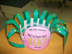 a paper basket with green and white strips on it that says we've been here 100 days