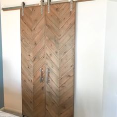 two wooden doors with metal handles in a room