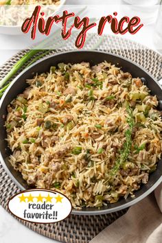 a pan filled with rice and vegetables on top of a table