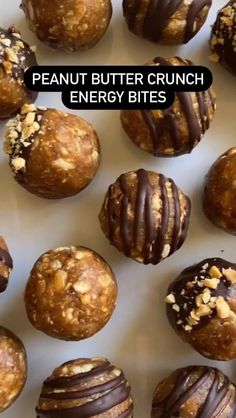 peanut butter crunch energy bites with chocolate drizzled on top and nuts in the middle