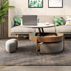 a living room filled with furniture and a laptop computer sitting on top of a table