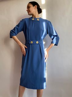 Very sophisticated 1950s dress Moderna Kleidung. Has very interesting details piping on bust decorated with big buttons. With two pleats on the waistline in the front and with a belt on the back. Has two zippers one small on the back and another one on the size. Dress has lining on the skirt. Unfortunately has no tags with material, but it looks likes light wool, but anyway the material is natural for sure, it is soft and smooth. In great condition. (When I took photos I clipped it at the back, so you'll be able to see the fit better, but when I made video I didn't clip it one the back. You'll be able to check measurements below🙂) (Measurements taken flat without stretching) Shoulders 40 cm/ 15.7 in Arm pit to arm pit 52 cm/ 20.4 in  Waist 42 cm/ 16.5 in  Hips 56 cm/ 22 in Length 102 cm/ Classic Blue Dress For Vintage Fashion, Vintage Belted Formal Dress, Vintage Formal Belted Dress, Blue Vintage Dress With Buttons For Vintage Fashion, Blue Vintage Dress With Buttons, Retro Belted Formal Dress, Retro Belted Dress For Formal Occasions, Blue Knee-length Vintage Dress For Vintage Fashion, Vintage Blue Elegant Dresses For Formal Occasions