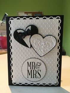 a wedding card with two hearts and a bow on the front that says mr & mrs