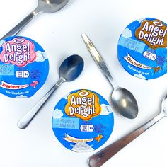 an assortment of desserts and spoons on a white surface with labels for angel delight